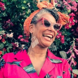 Designer Karen Arthur in pink dress laughing