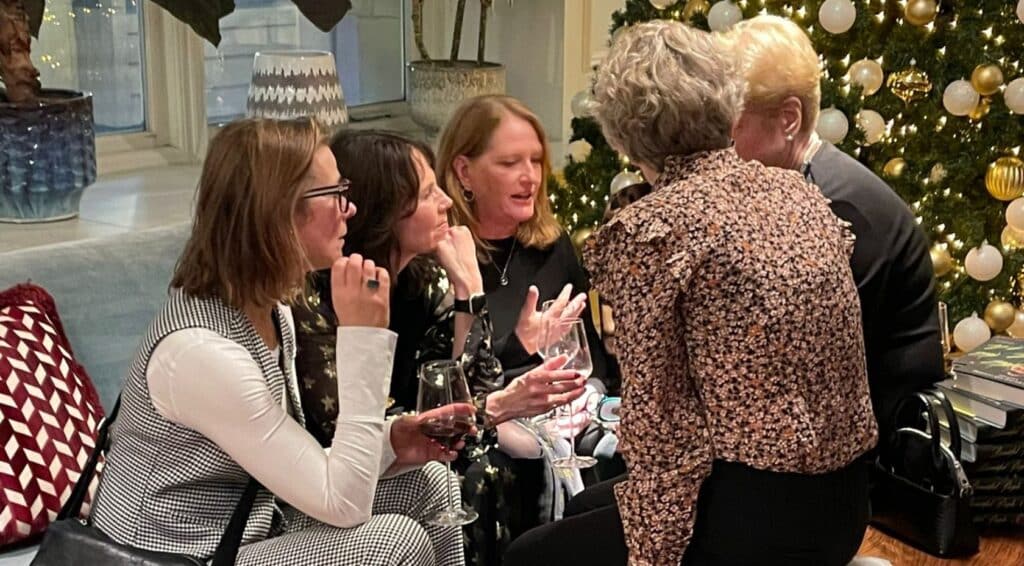 Group of midlife women of NOON chatting at NOON Christmas party 2024