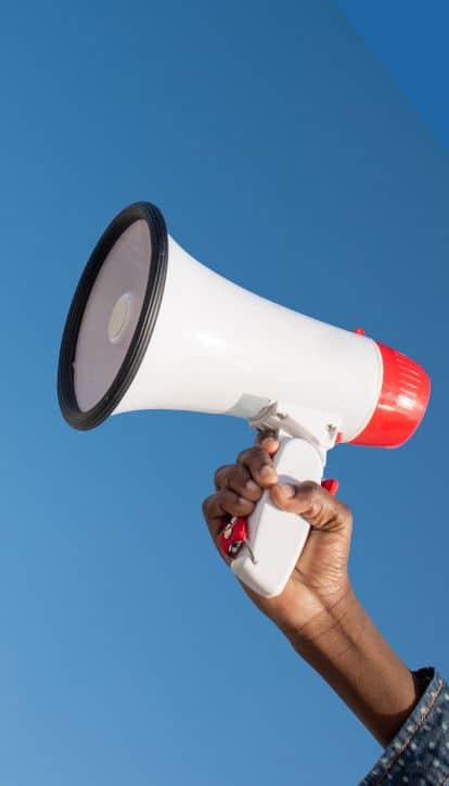 Woman's hand with loudhailer aka megaphone