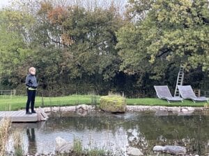 attendee looking at swimming pond at NOON Wales Retreat