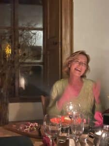 Queenager Helen laughing at a supper at the NOON Wales retreat