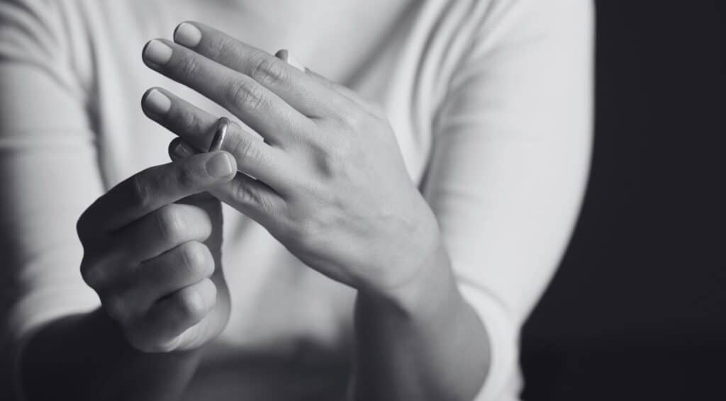 woman taking off ring to illustrate How to have a good divorce webinar